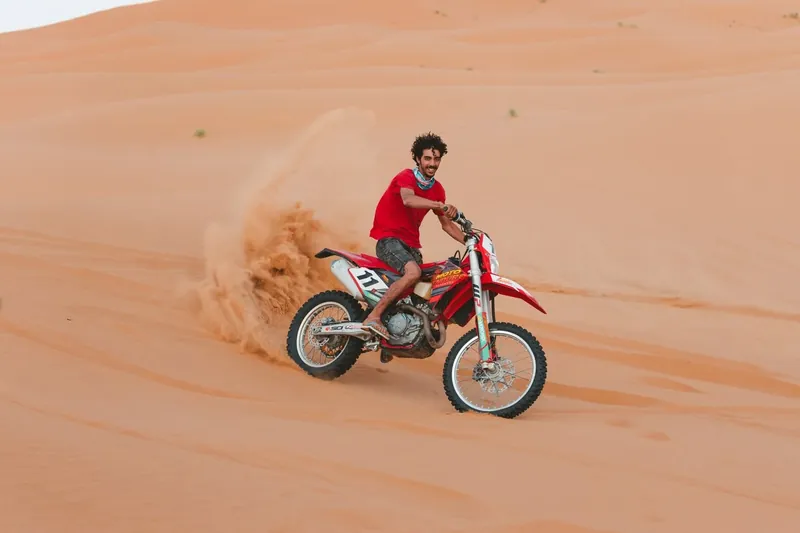 Enduro motorcycle riding in the dunes near Merzouga, Morocco